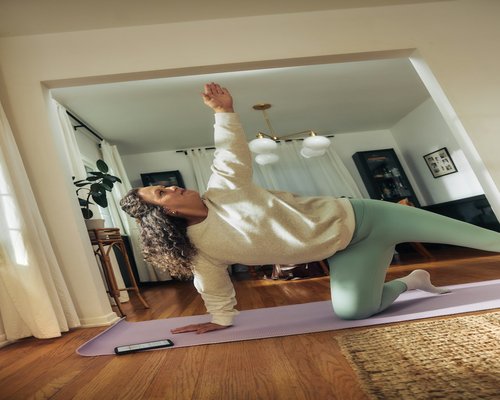 Person doing gentle stretching exercises on a yoga mat at home